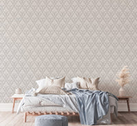 White color mini damask design wallpaper behind a bed with blue and beige linens.
