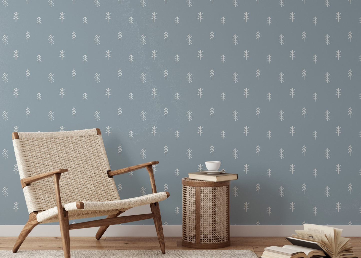 White pine tree wallpaper in seating nook with wooden chair and side table.