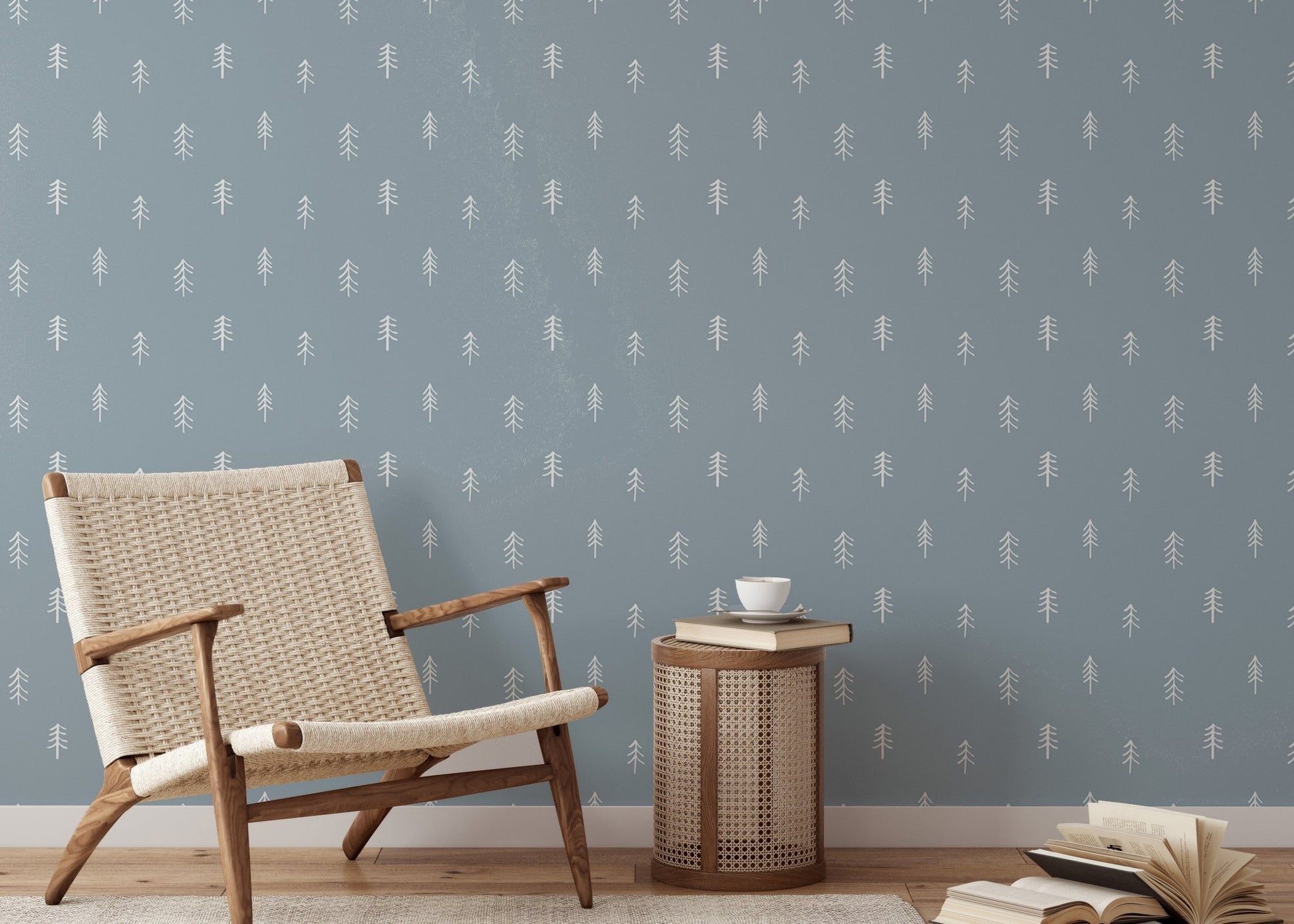 White pine tree wallpaper in seating nook with wooden chair and side table.