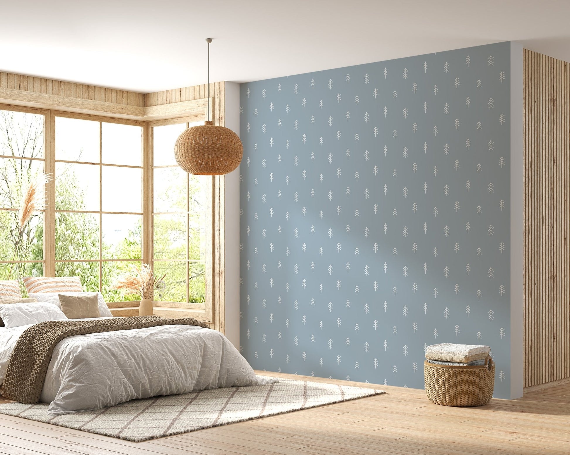 Blue and white tree wallpaper in spacious bedroom with wooden floors.