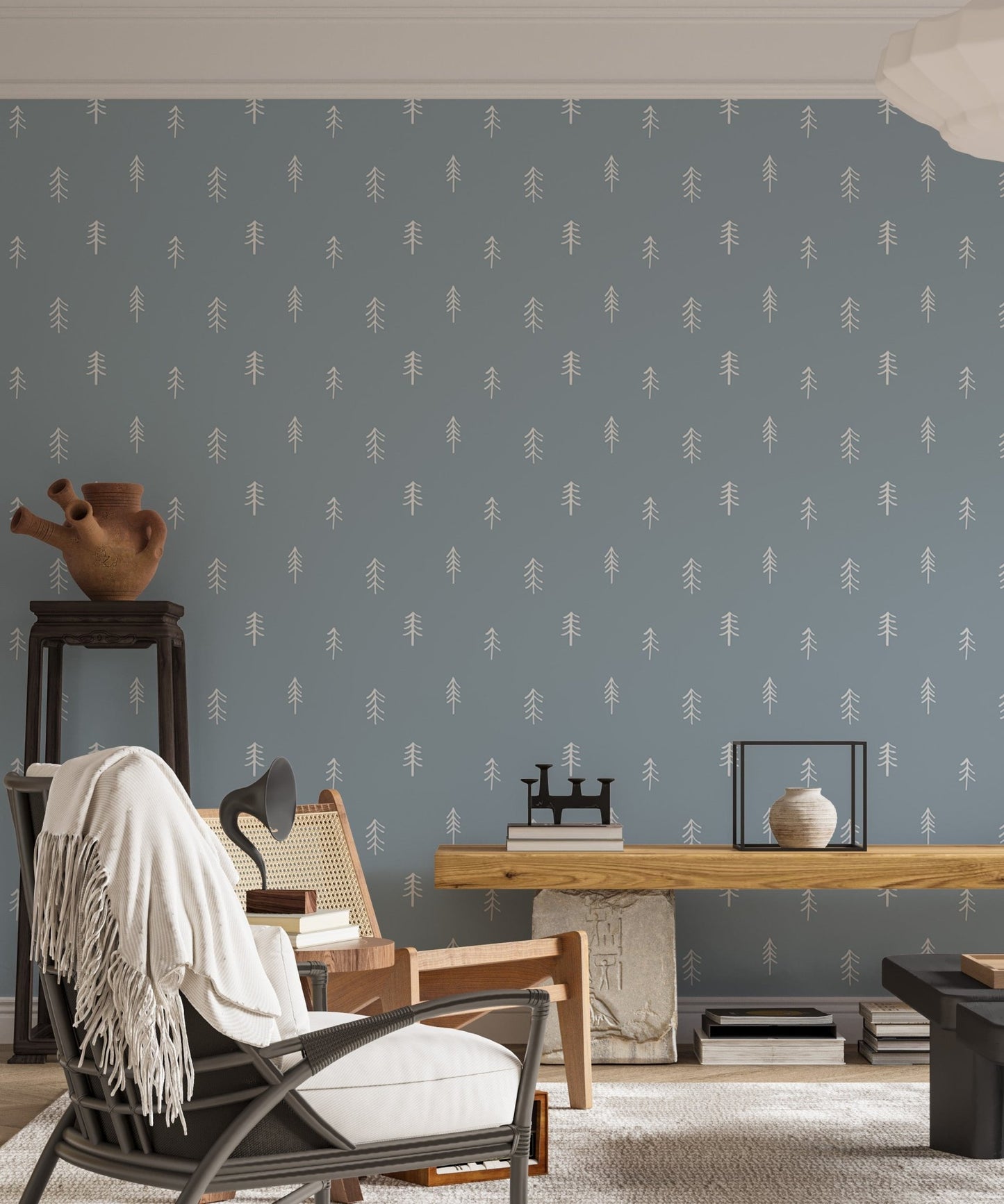 Pine tree pattern wallpaper in living room with black chair and side table.