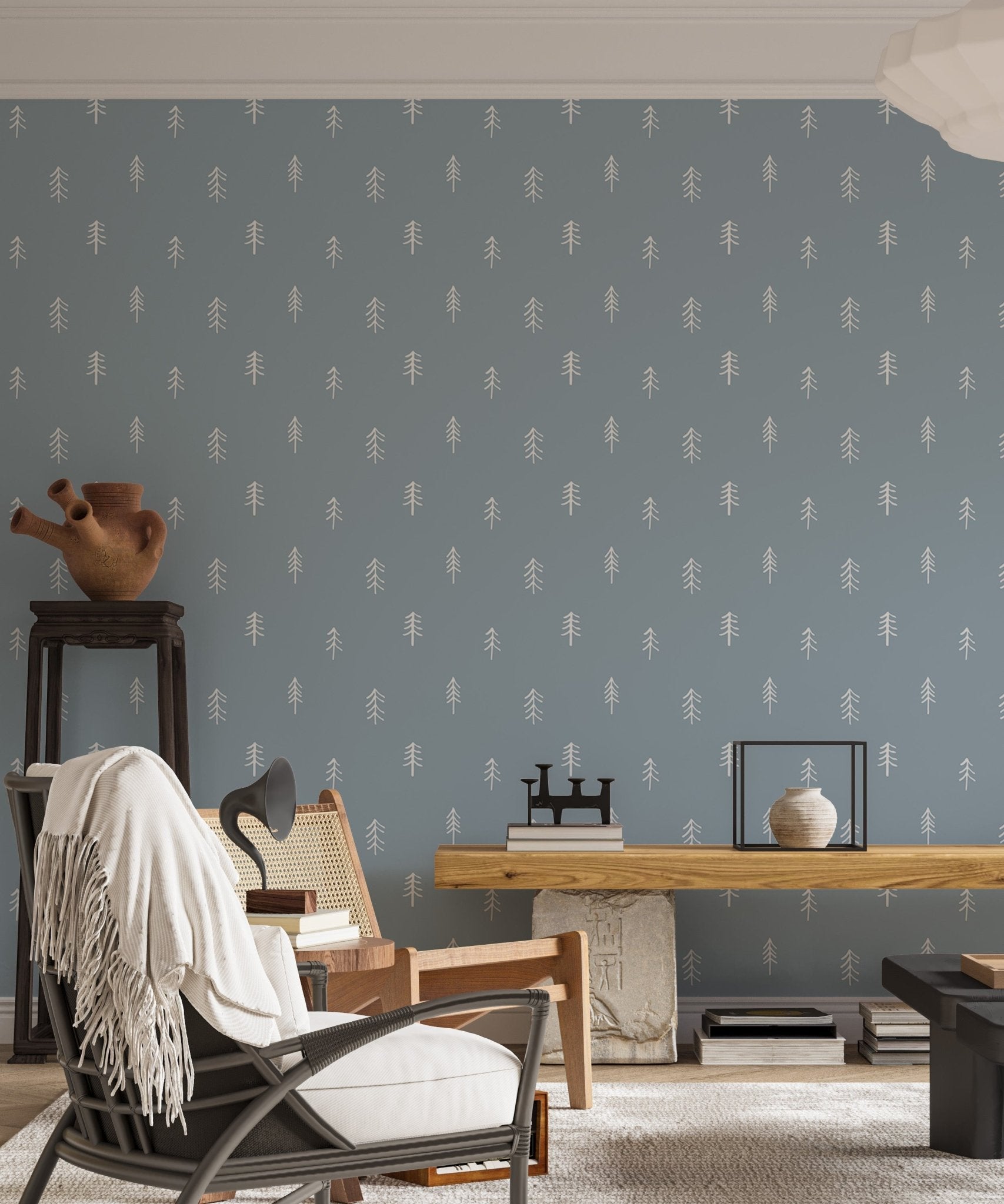 Pine tree pattern wallpaper in living room with black chair and side table.