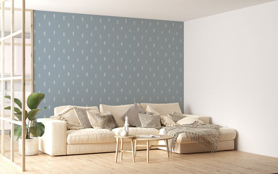 Large wallpaper featuring pine trees behind white sofa and neutral rug.