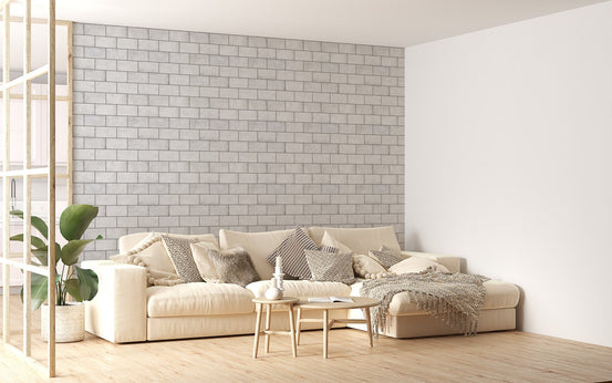 White winter frost brick wallpaper in living area behind beige sofa.