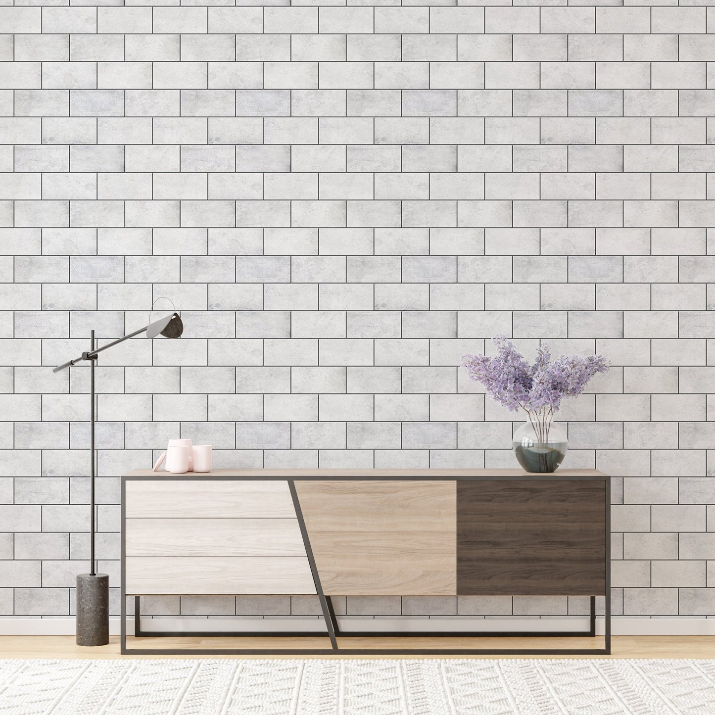 Modern console table with lamp against a light textured brick wallpaper.