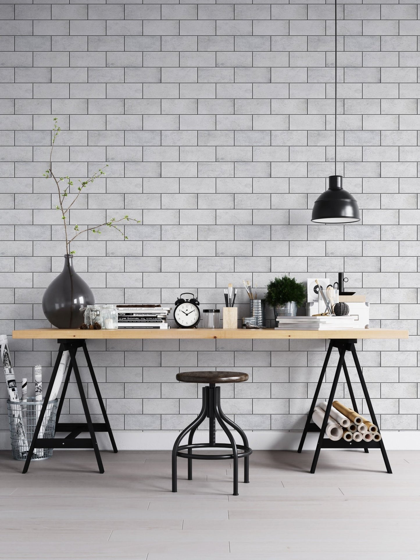 Desk with black lamp against a light grey brick wallpaper.