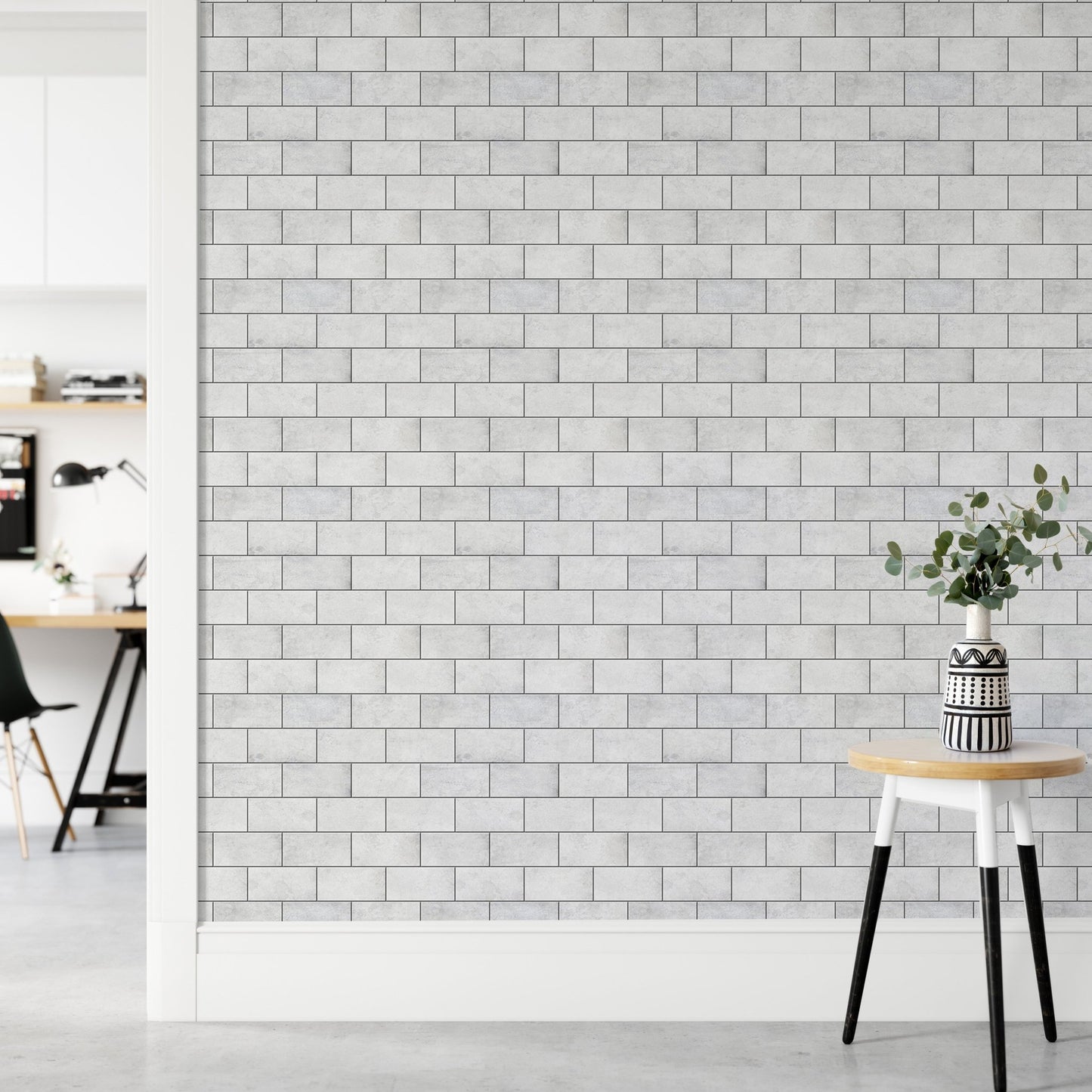 Minimalist hallway with white brick wallpaper and a wooden stool.