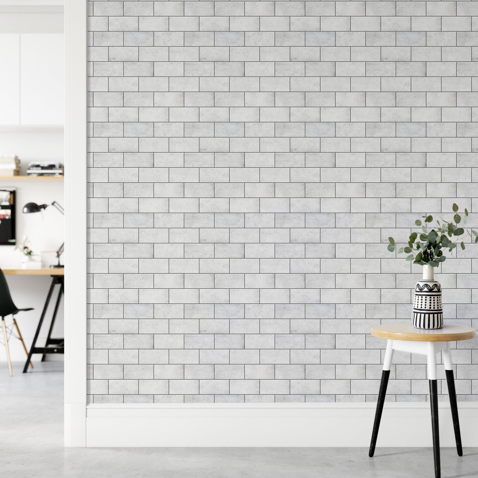 Minimalist hallway with white brick wallpaper and a wooden stool.