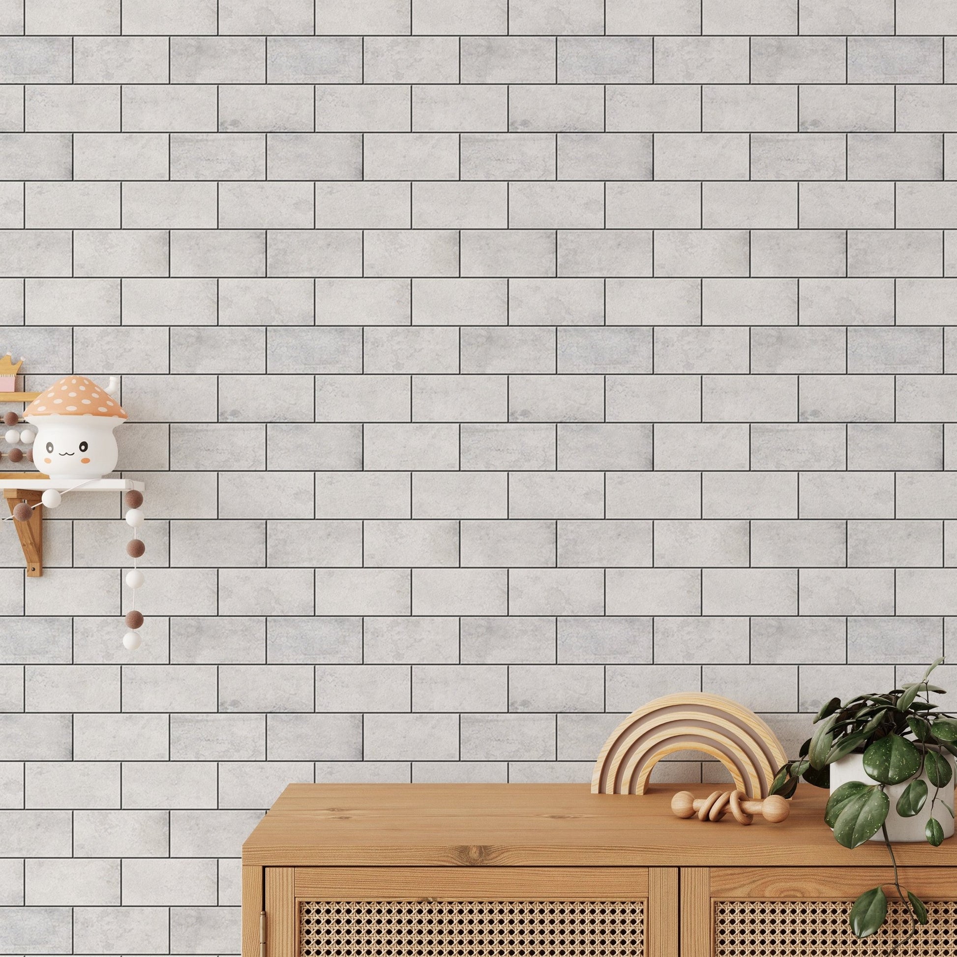 Textured white brick wallpaper behind a wooden sideboard and nursery decor.