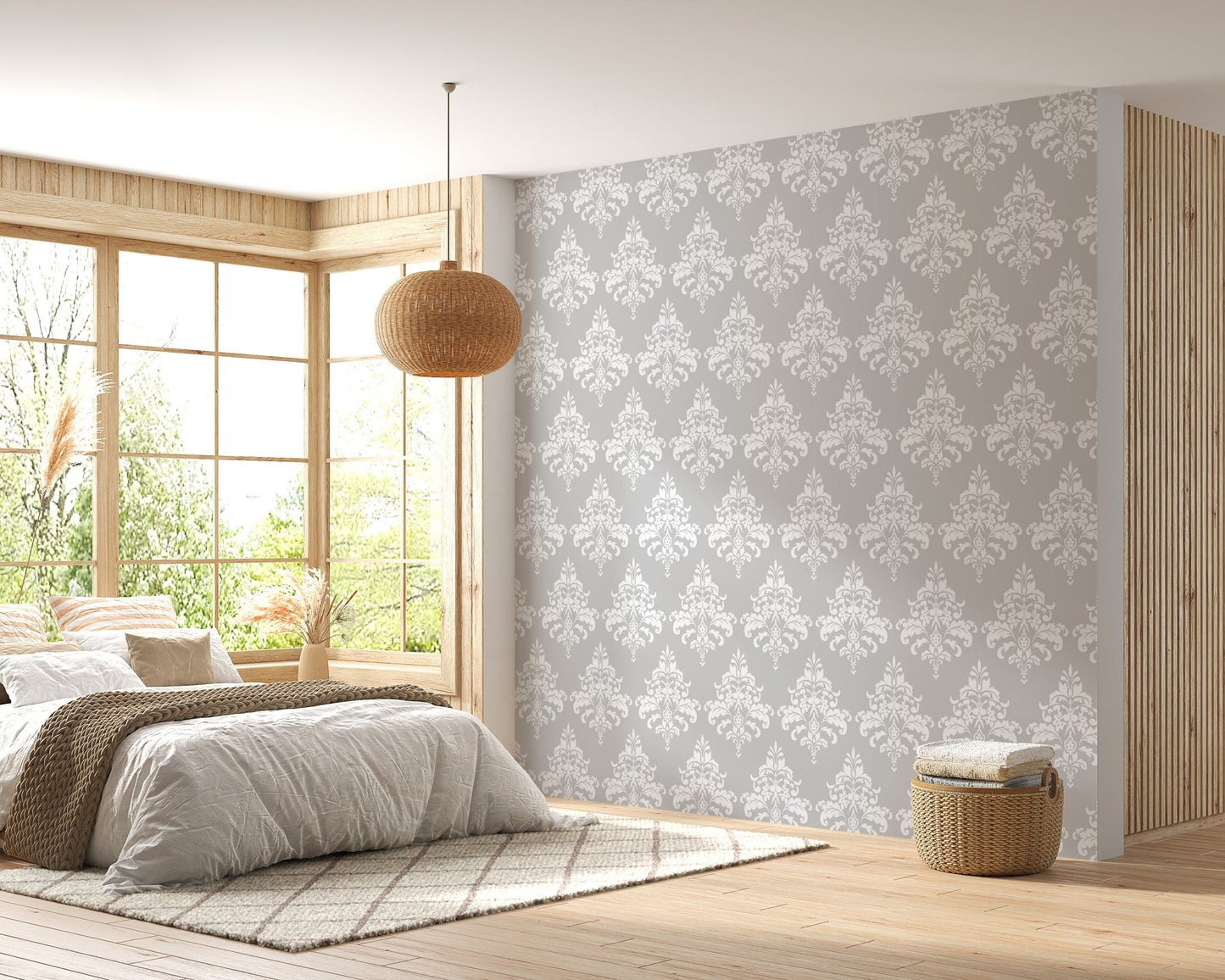 Grey and white damask wallpaper in a bedroom with natural wood flooring and bed.