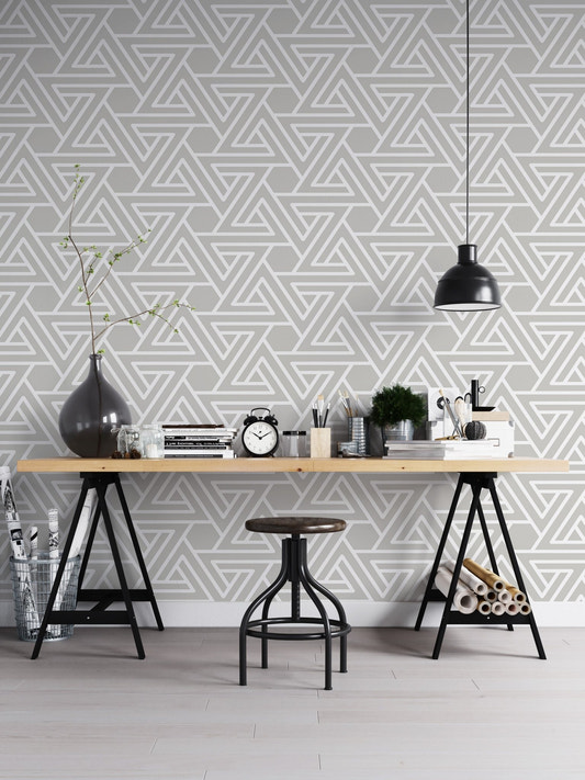 Modern home office with grey geometric pattern wall mural and wooden desk.