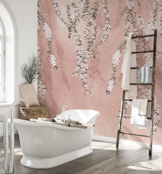 Freestanding tub in a bathroom with white orchid flower wall mural.