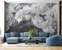 Large scale orchids wall mural behind a dark blue L-shaped sectional sofa.