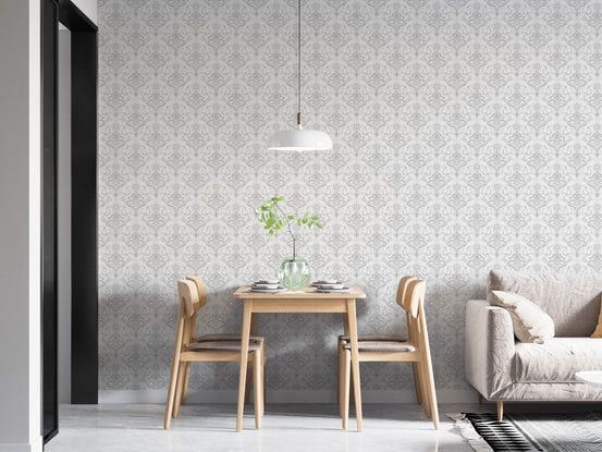 Minimalist dining area featuring white damask pattern wallpaper and hanging light.