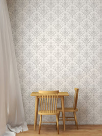 Grey floral damask removable wallpaper behind a small wooden dining table.