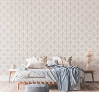 Bedroom interior featuring grey damask wallpaper behind a bed with blue linens.