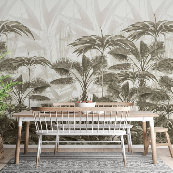 Wooden dining table set against a Wild Palm Canopy wall mural in olive green.
