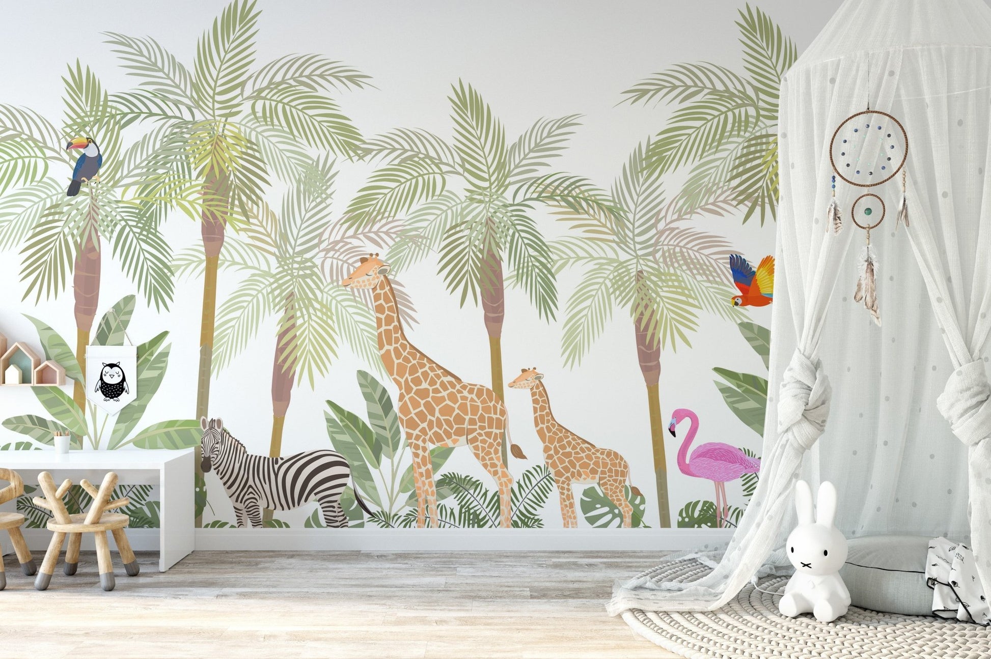 Palm tree wall mural behind a white teepee tent and soft nursery toys.