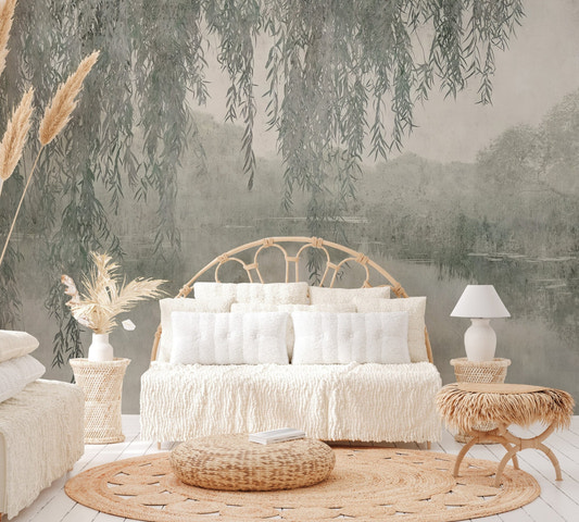 Willow branches hanging over a misty lake wall mural with soft reflections.