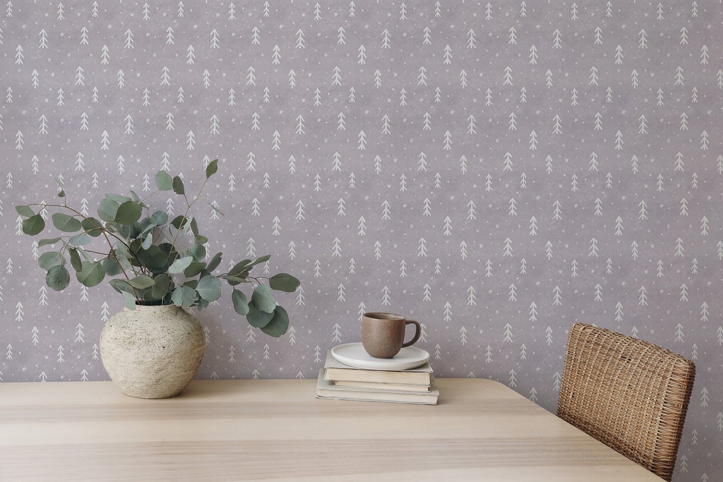 Textured grey snowflakes wall mural with white leaf patterns behind a vase on a desk.