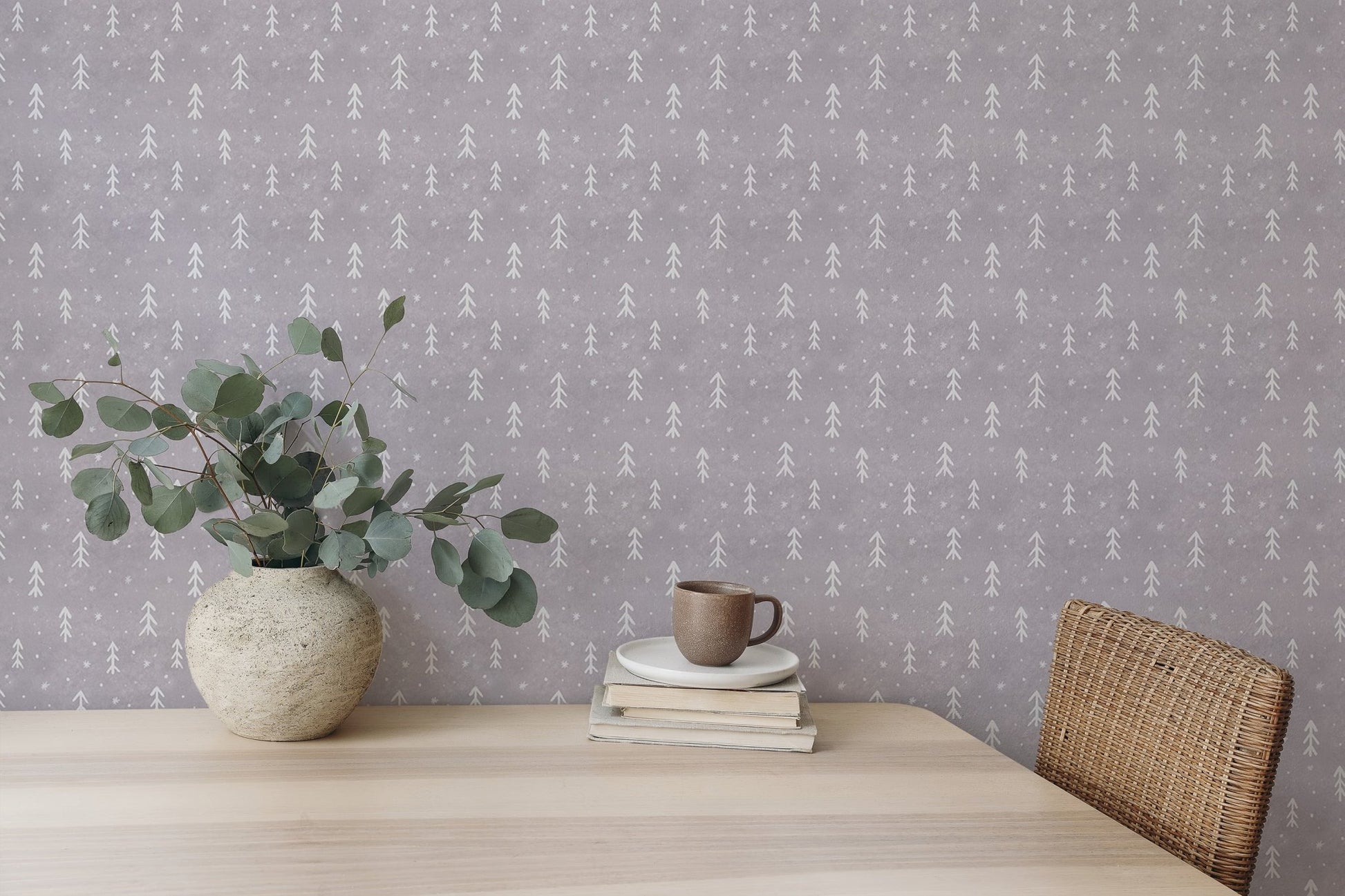 Textured grey snowflakes wall mural with white leaf patterns behind a vase on a desk.