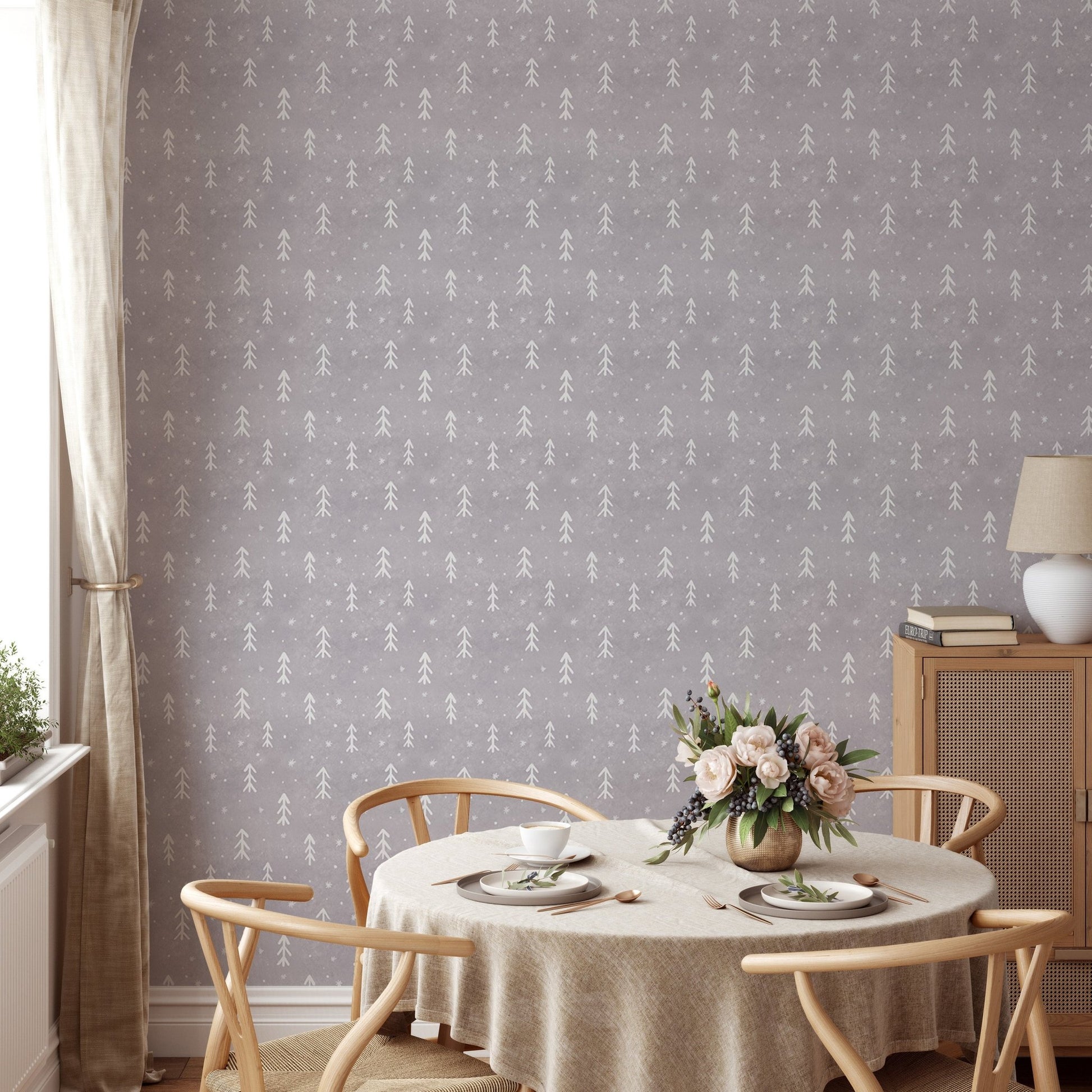 Grey snowflake wall mural behind a round dining table and light wood chairs.
