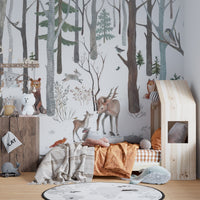Snowy woodland wildlife wallpaper mural with deer and bear illustration.