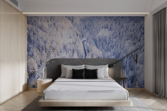 Winter wonderland forest wallpaper featuring a winding road through snowy pines.