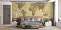 Bedroom interior featuring a world map wall mural behind a dark bed frame.