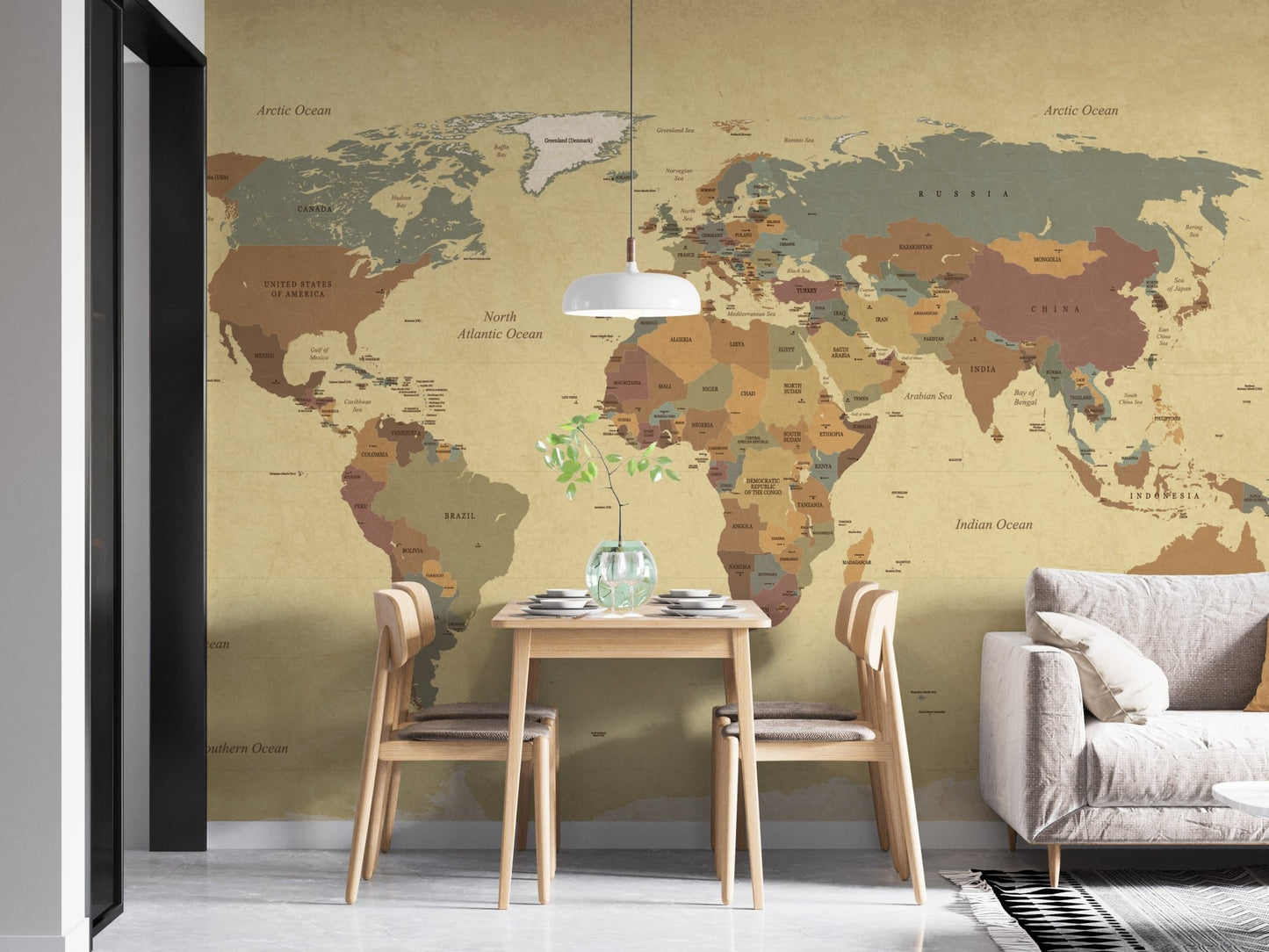 Small dining area with world map wall mural and two wooden chairs.