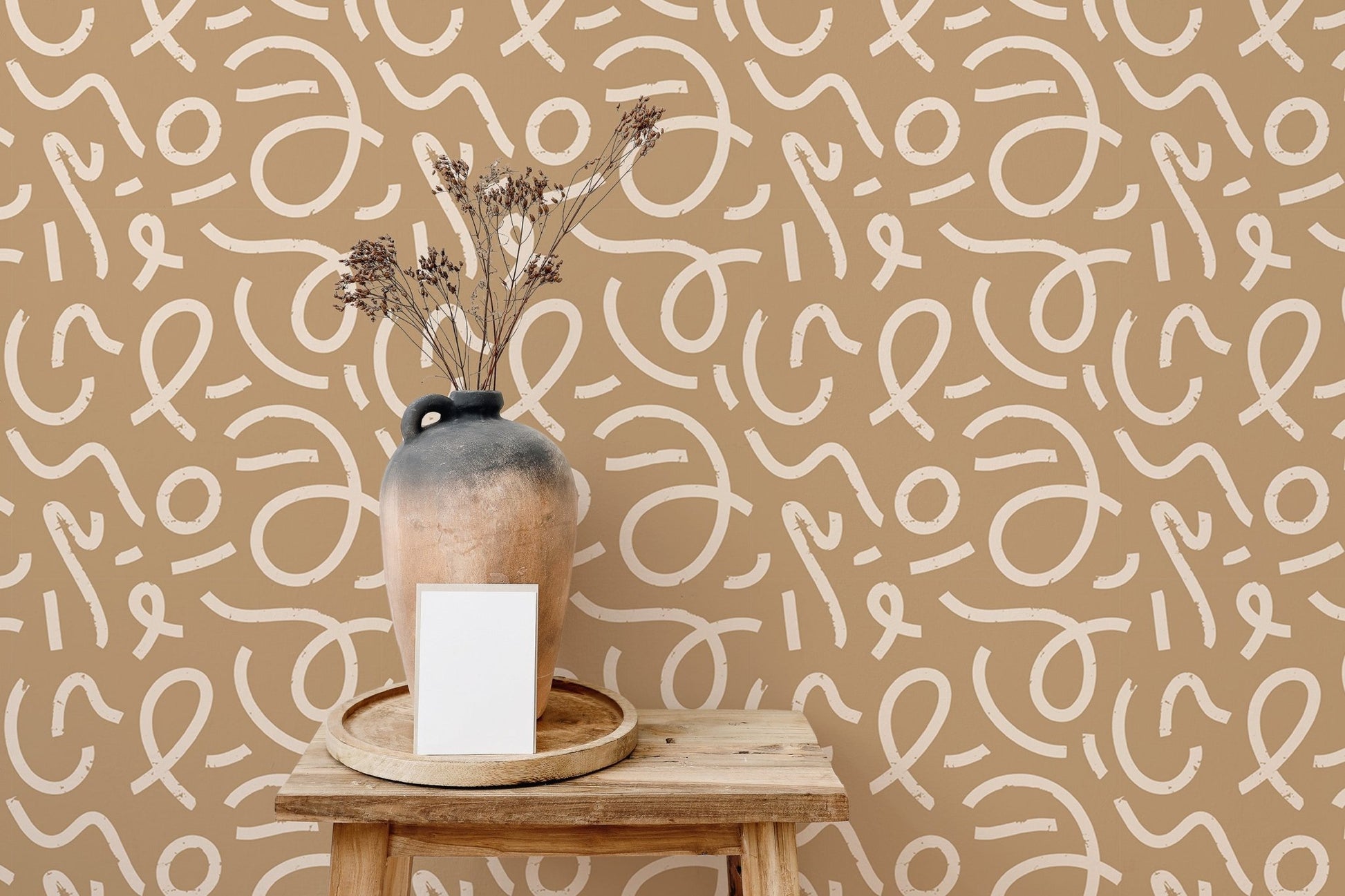 Dining area wallpaper featuring tan background and white abstract loops