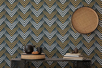 Abstract chevron wallpaper paired with a circular wicker wall hanging and black console.