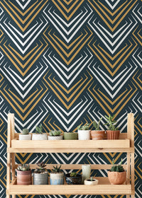 Geometric chevron wallpaper behind a wooden shelf holding multiple potted succulents.