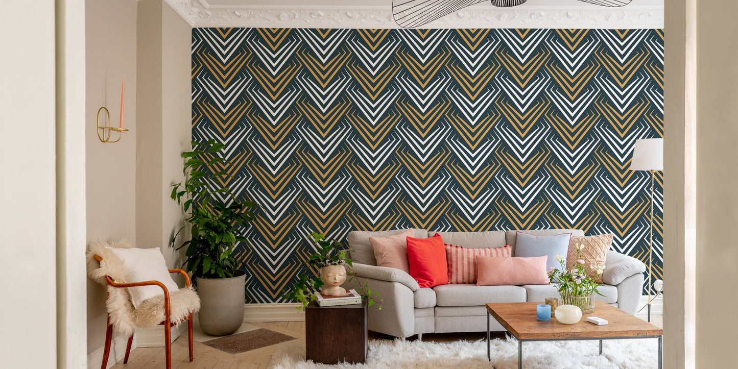 Symmetrical chevron wallpaper in a modern apartment living room with a grey couch.