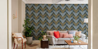 Symmetrical chevron wallpaper in a modern apartment living room with a grey couch.