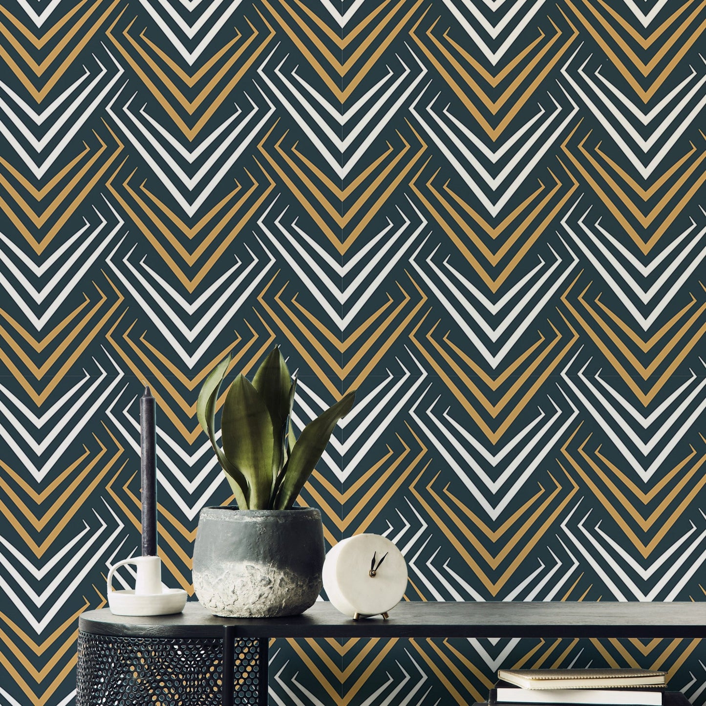 Yellow and White Vintage Abstract Art Deco Wallpaper behind a plant on a black table.