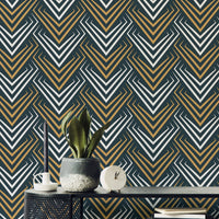 Yellow and White Vintage Abstract Art Deco Wallpaper behind a plant on a black table.