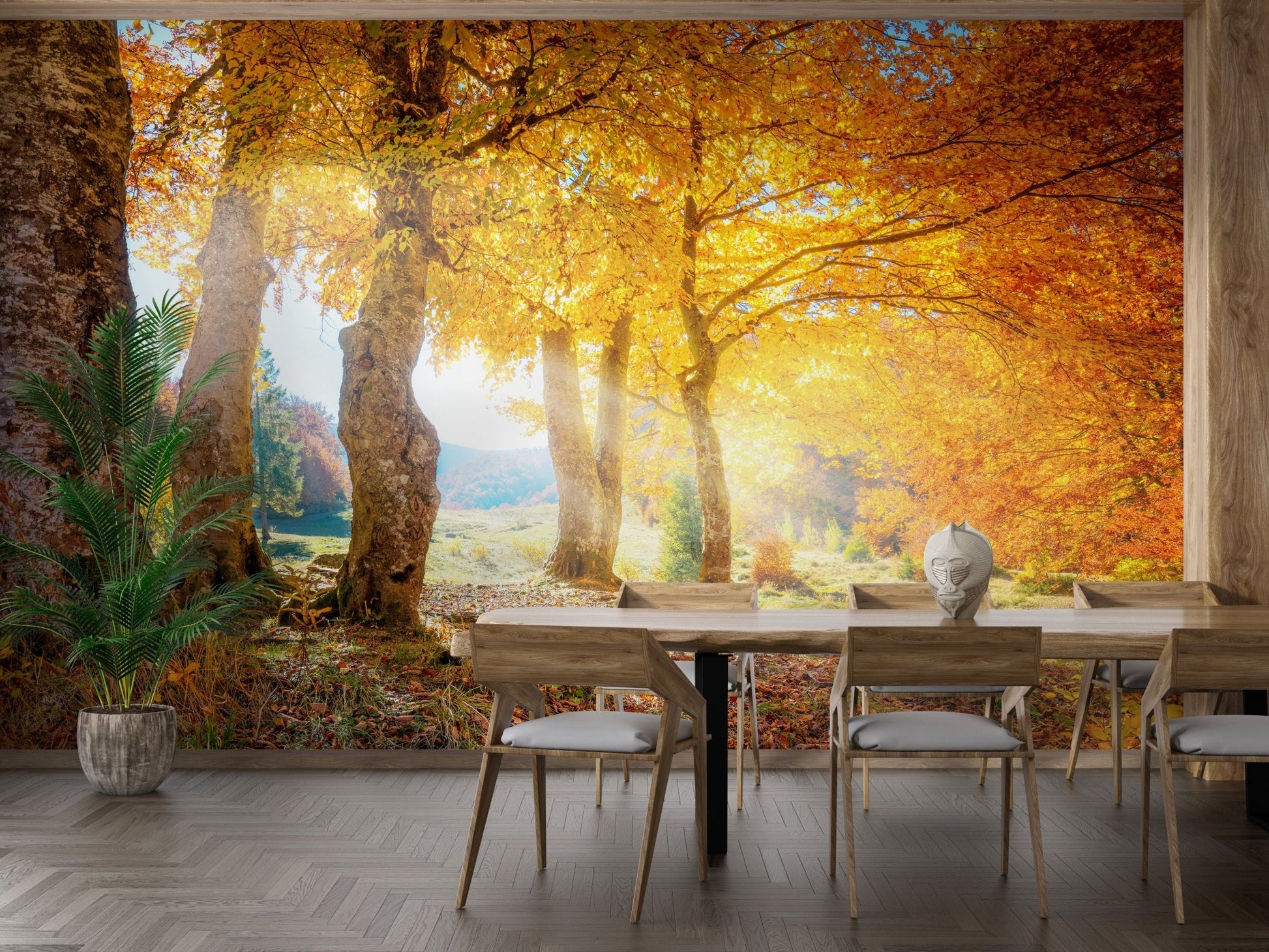 Forest tree wall mural in a dining room featuring a long wooden table and plant.