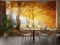 Forest tree wall mural in a dining room featuring a long wooden table and plant.